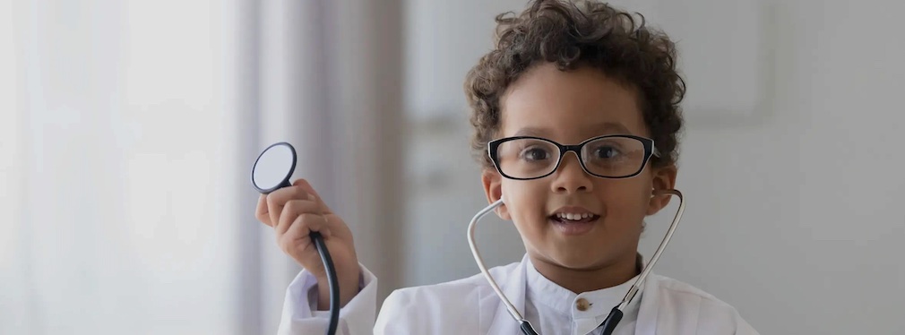 Young boy dressed up as a doctor holding a stethoscope
